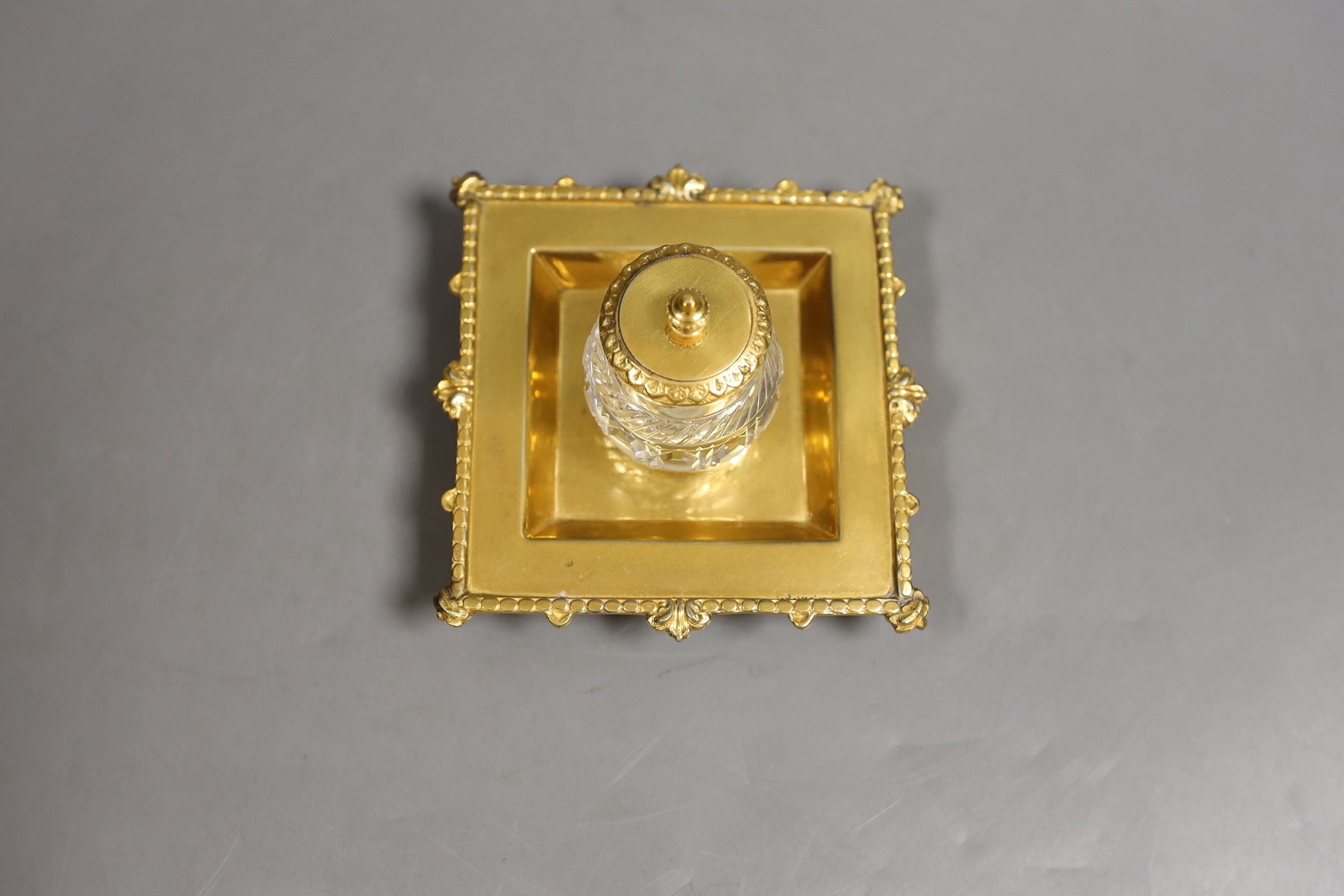 A gold plated inkstand, 7 cms high.